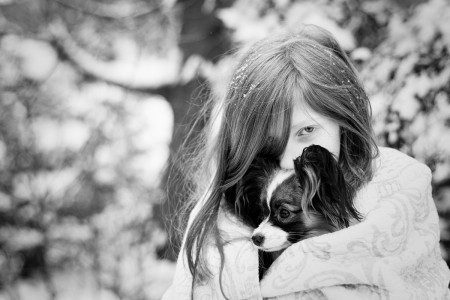 papillon puppy and girl in snow Massachusetts_dog_photography Film_photographer_NH film_photography_new_england black_and_white_photography_Massachusetts_